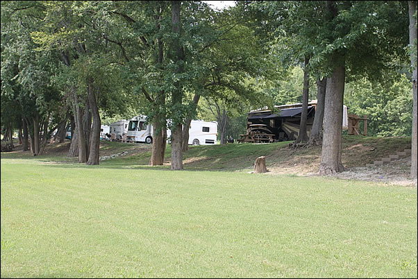 large yard between riverfront campsites and the Ohio River