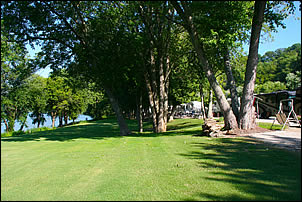 large yard between riverfront campsites and the Ohio River